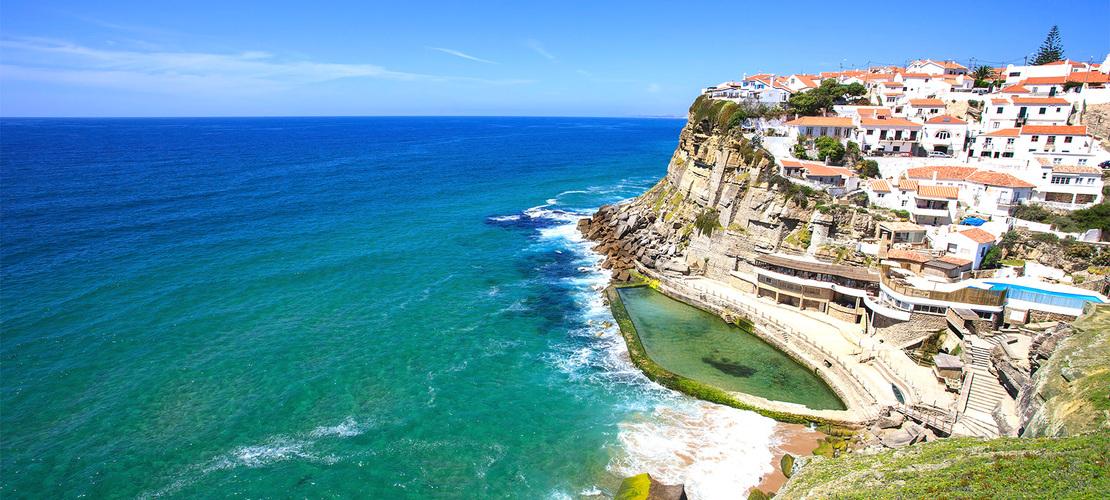 sea cliff with so many buildings on cliff and sea on the other side