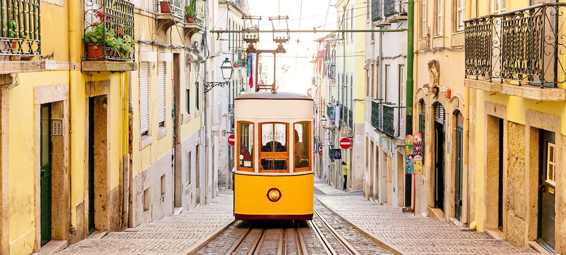 tram train with track and buildings on either side